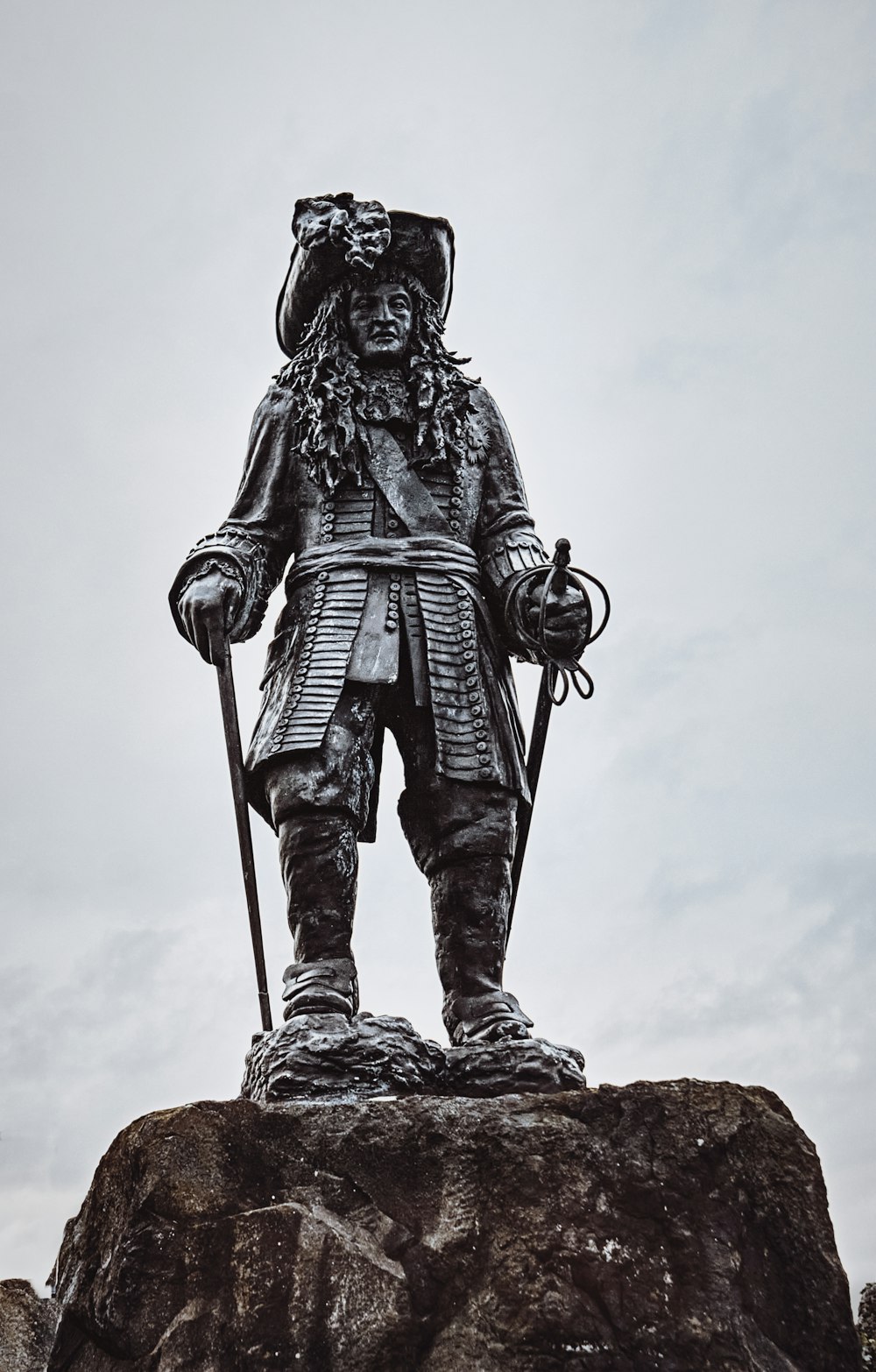 man in black coat statue