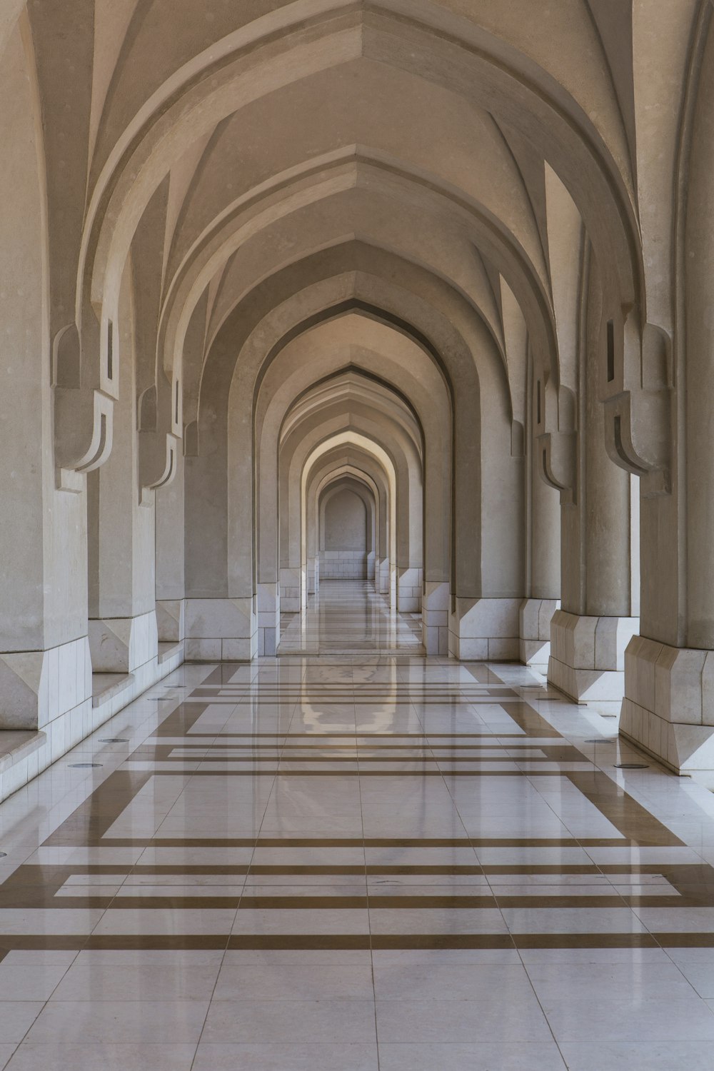 people walking on brown and white hallway