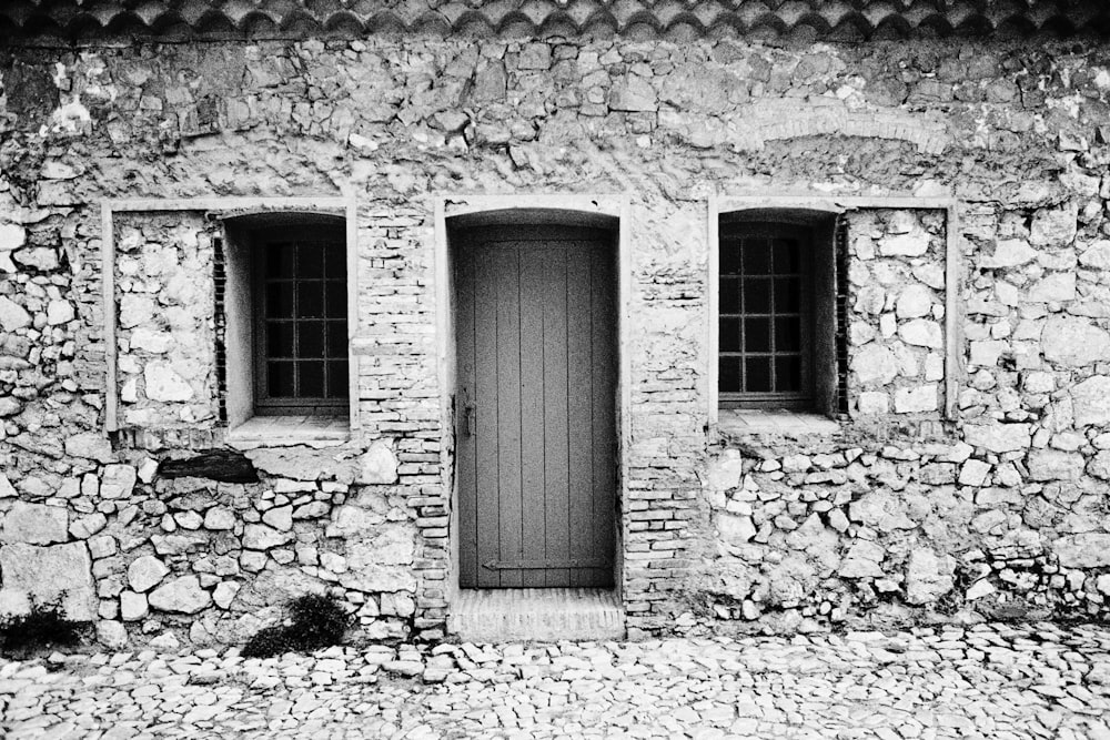 grayscale photo of wooden door