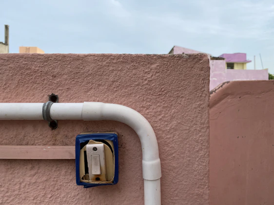 A friendly technician fixing a light switch in a cozy Kanpur home.