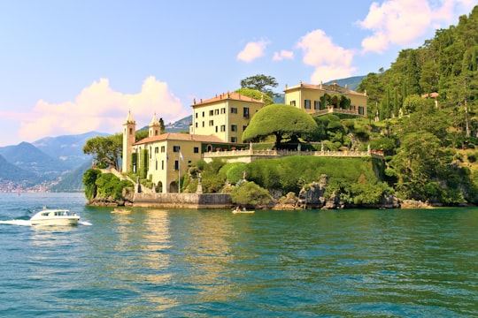 white concrete building near body of water during daytime in Villa del Balbianello Italy