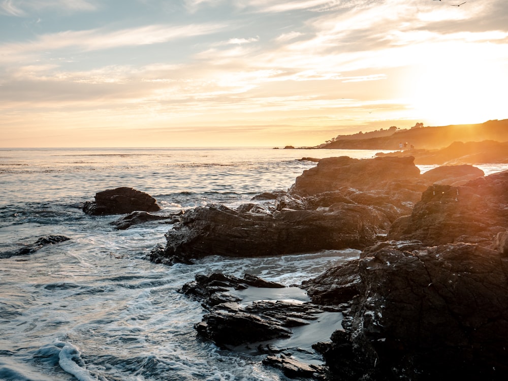 rocky shore during sunset with ocean waves