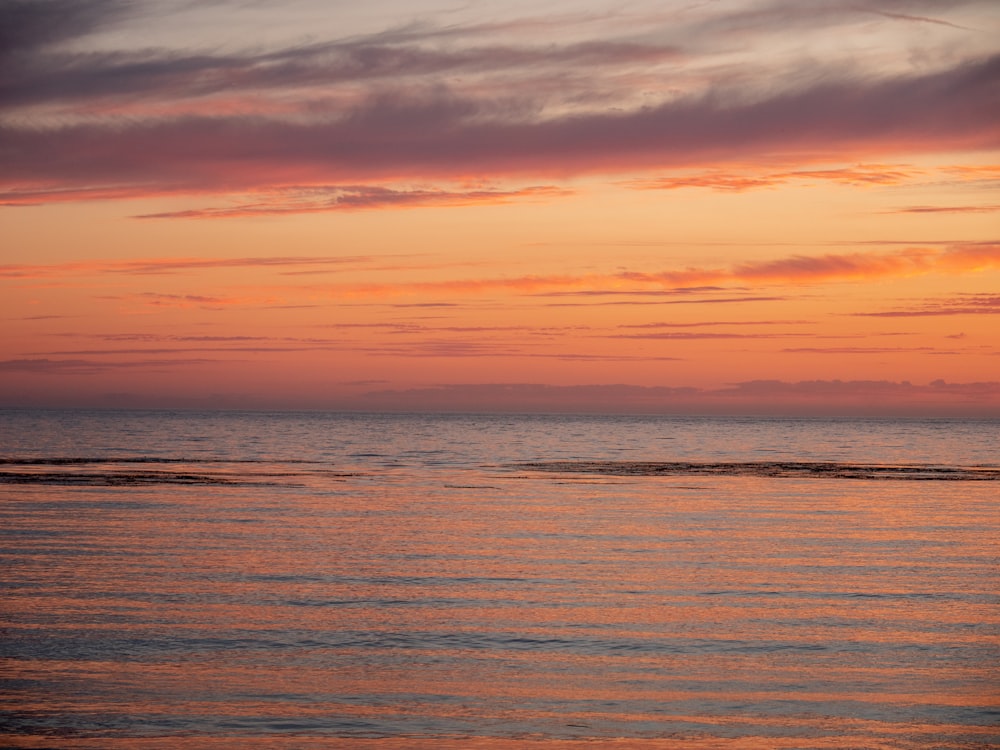 body of water during sunset