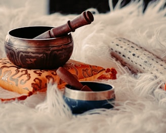 brown wooden mortar and pestle on white textile