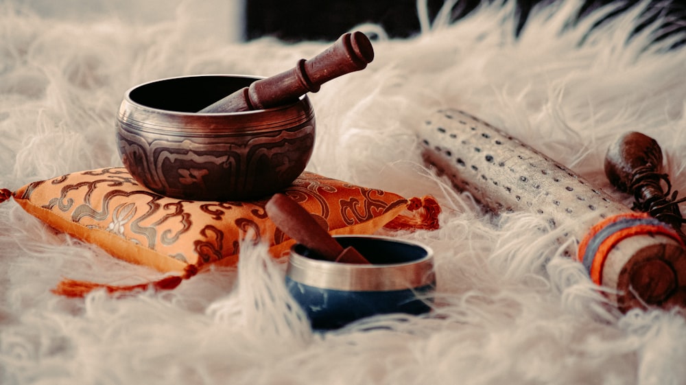 brown wooden mortar and pestle on white textile