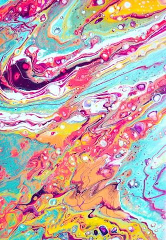 A vibrant abstract painting with swirling patterns and flowing lines in bright, bold colors. There are dynamic fluid shapes and a marbled effect, creating a sense of movement and energy.