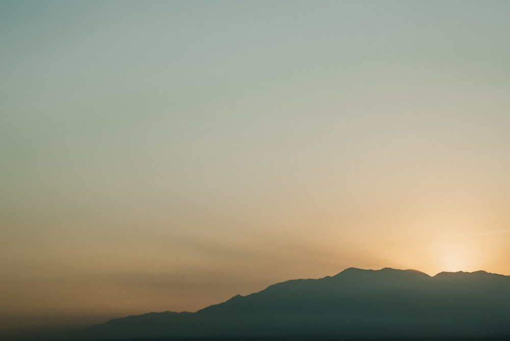 silhouette of mountain during sunset