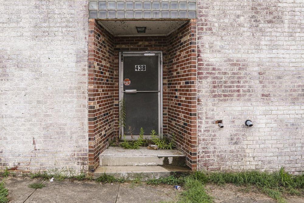 brown brick wall with black door