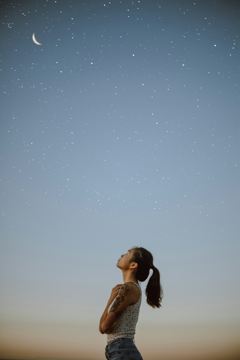 woman in black tank top under blue sky during daytime