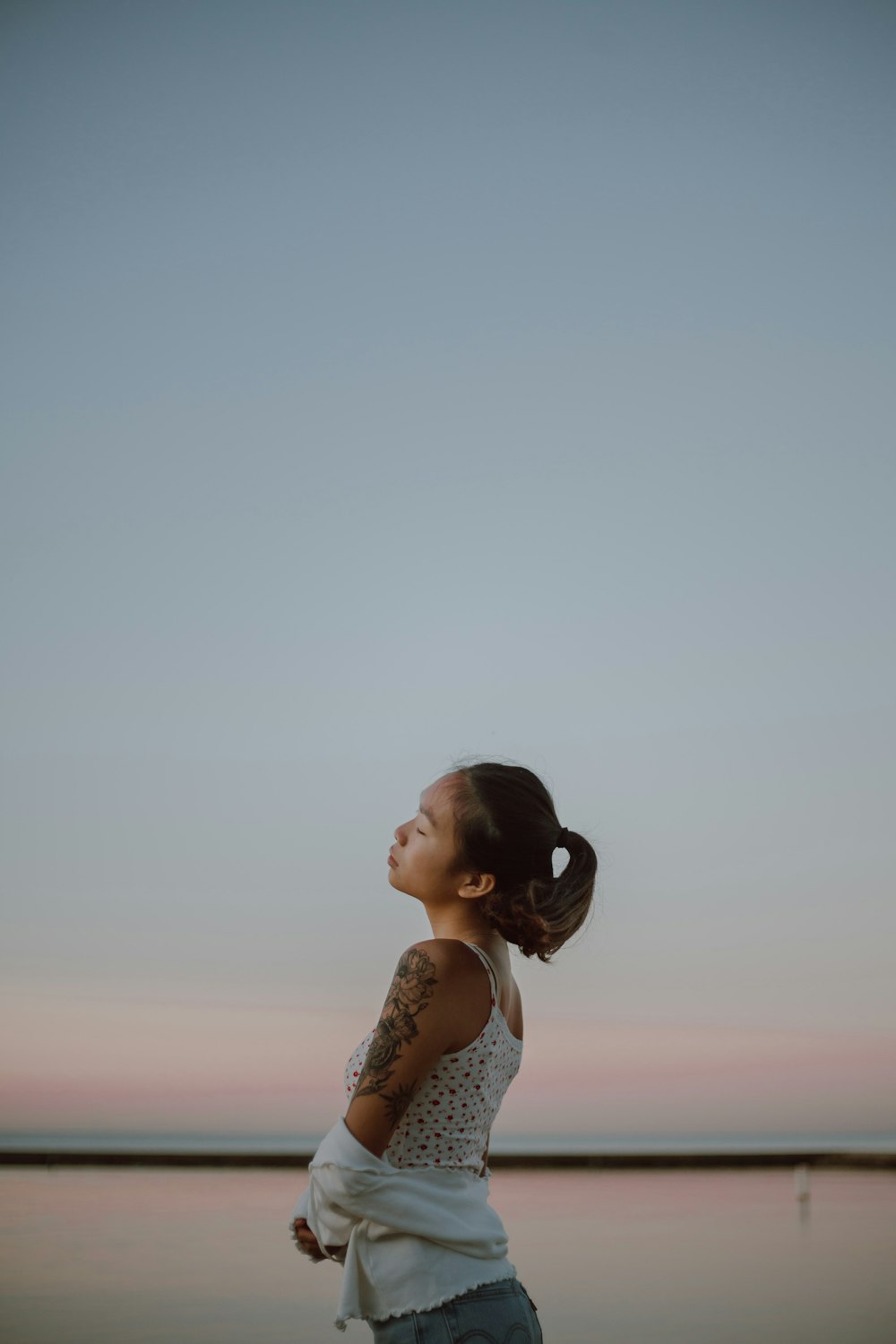 woman in white tank top and white floral skirt