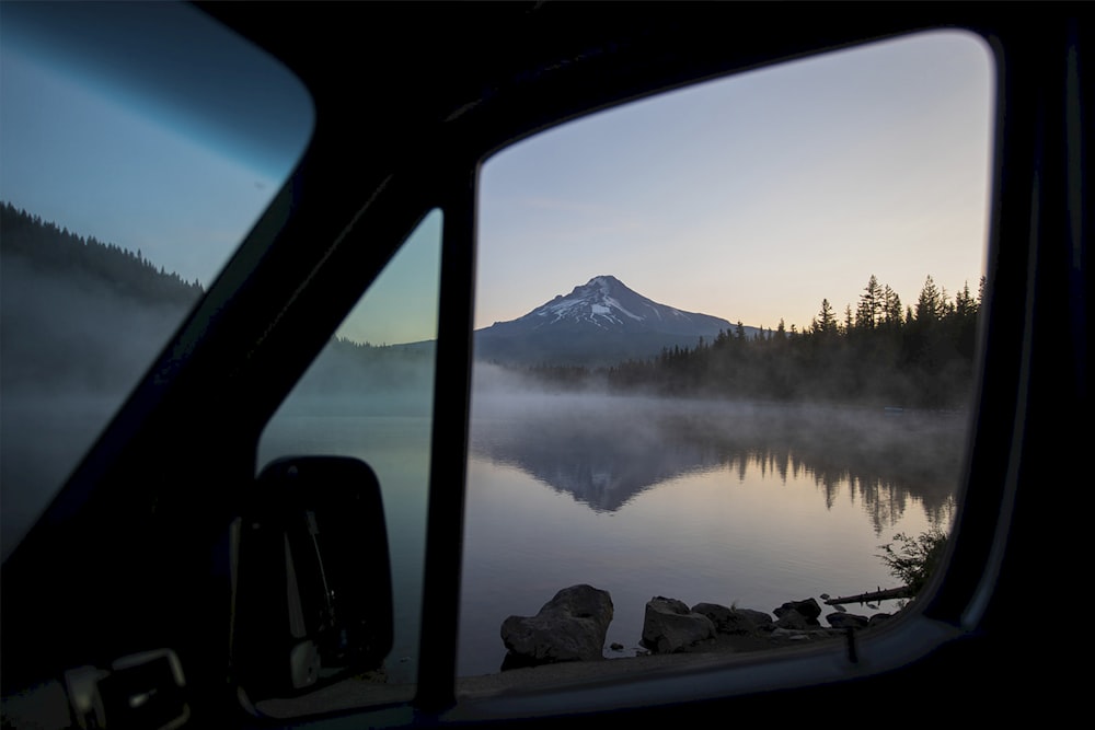 body of water near mountain during daytime