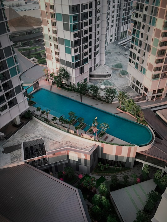 people swimming in pool near building during daytime in I-City Malaysia