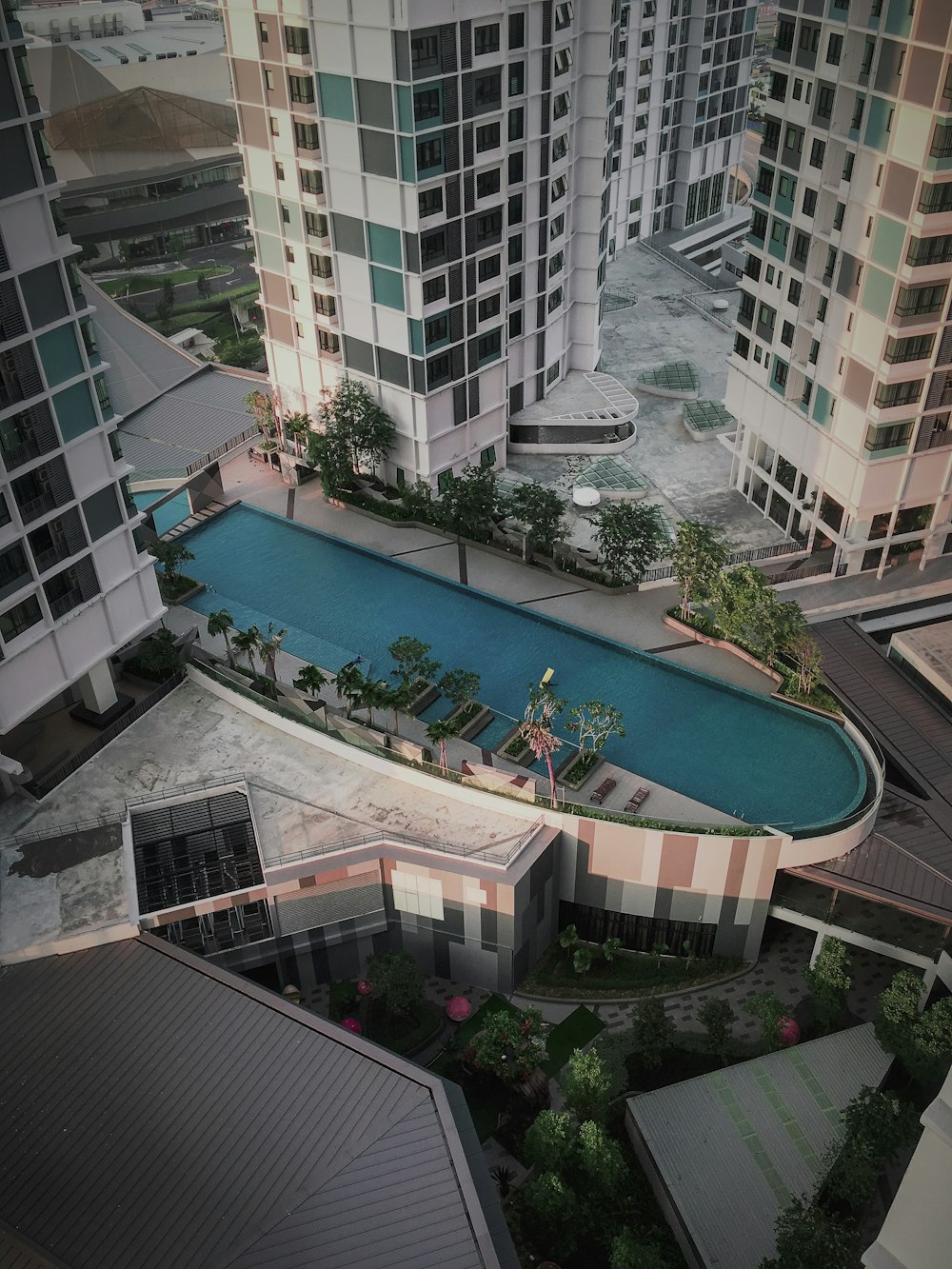 people swimming in pool near building during daytime