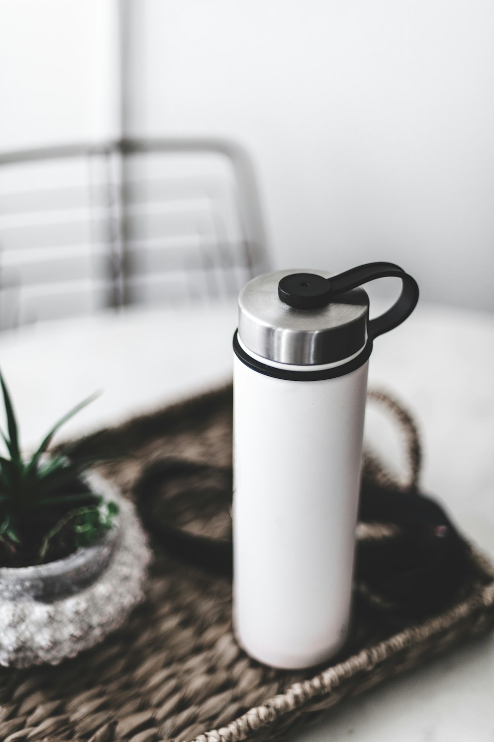 white and silver thermal carafe on brown wooden table