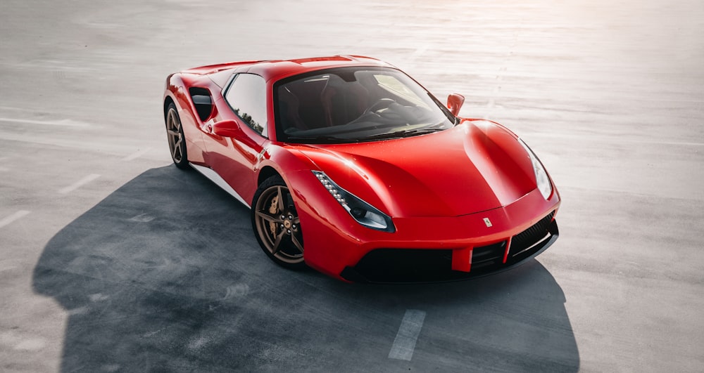 red ferrari 458 italia on gray pavement