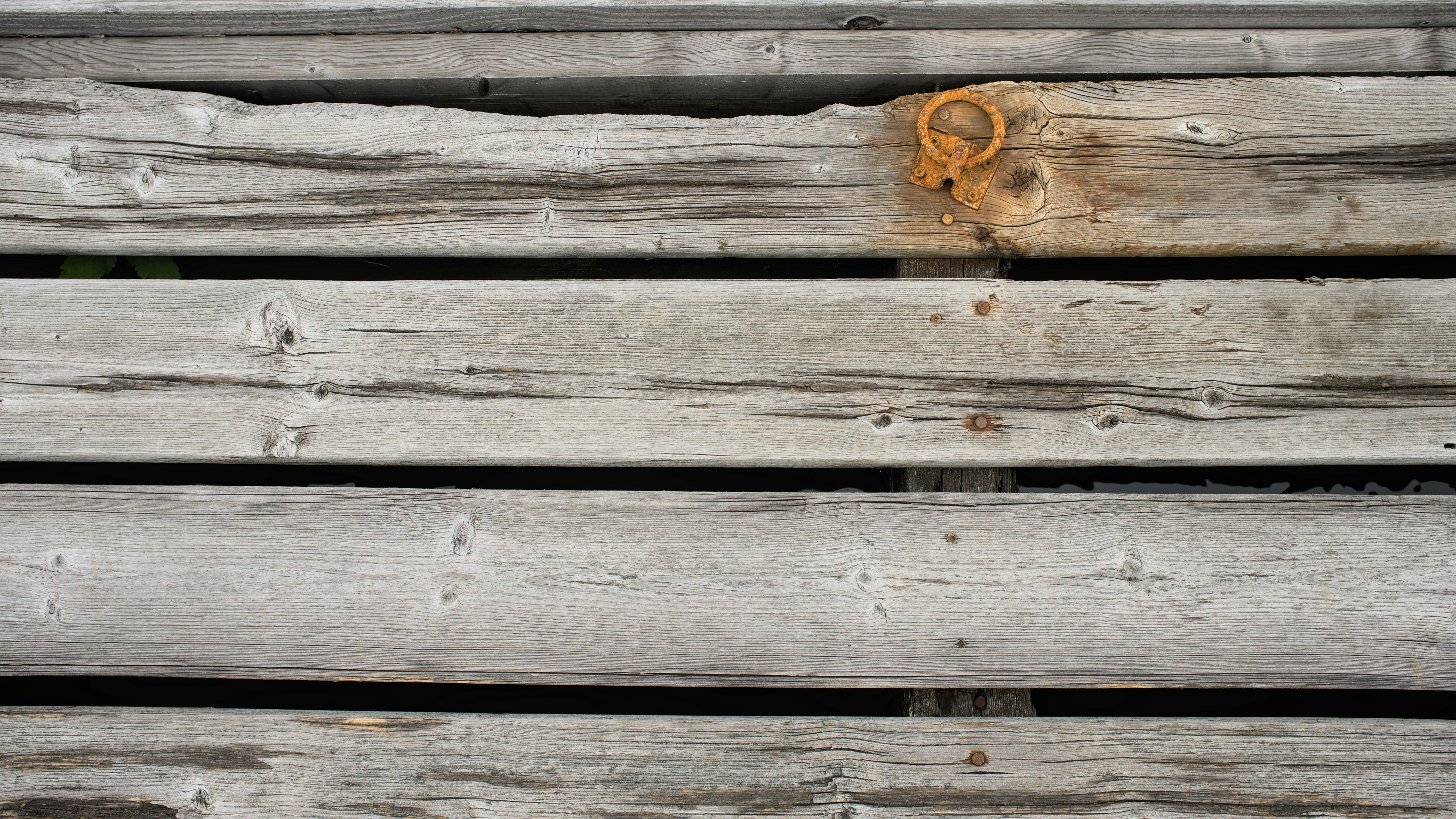 Weathered wooden deck surface with rusty metal ring