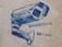 A stencil graffiti of a surveillance camera in blue on a concrete wall, accompanied by text in Greek.