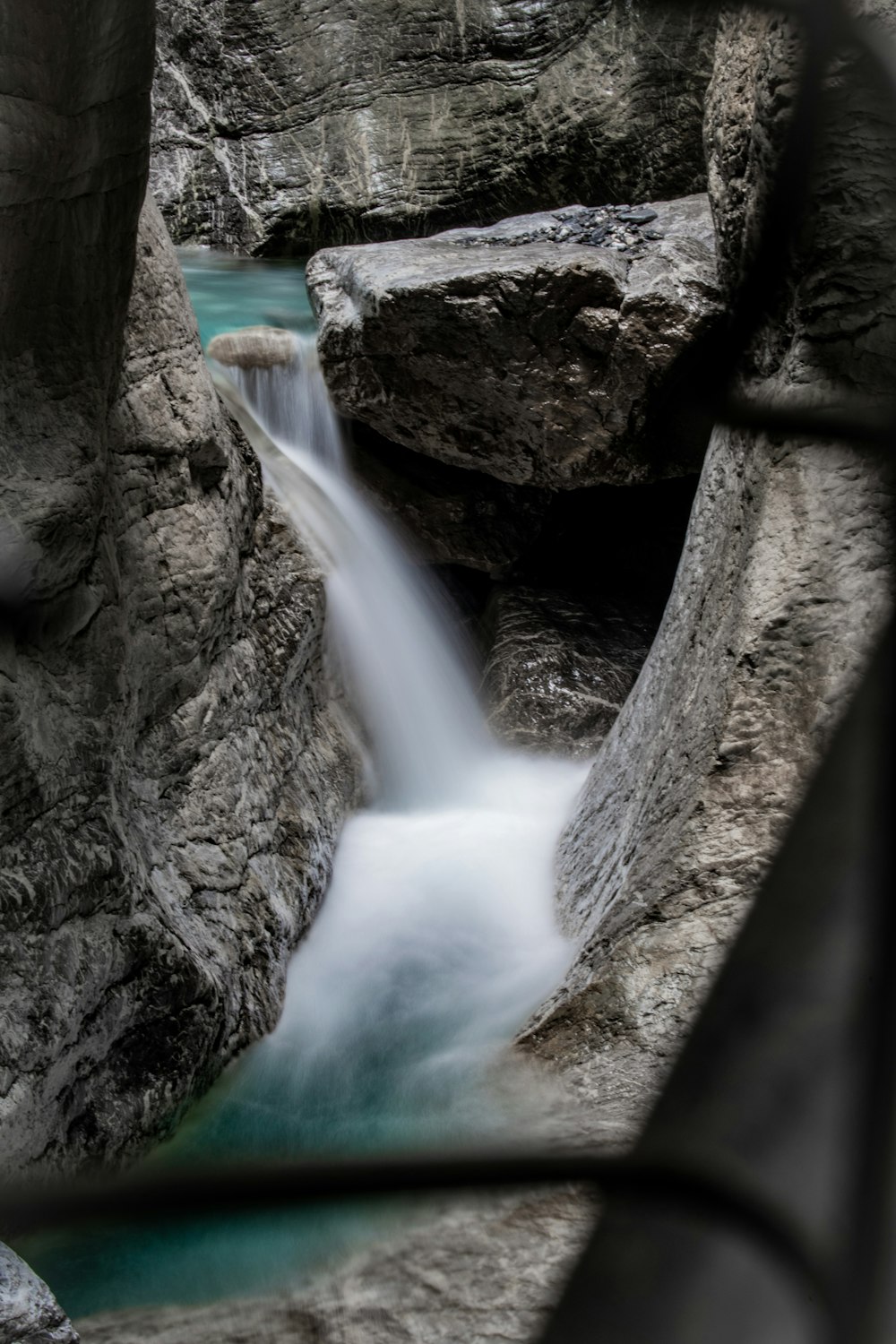 white bird flying over the water falls