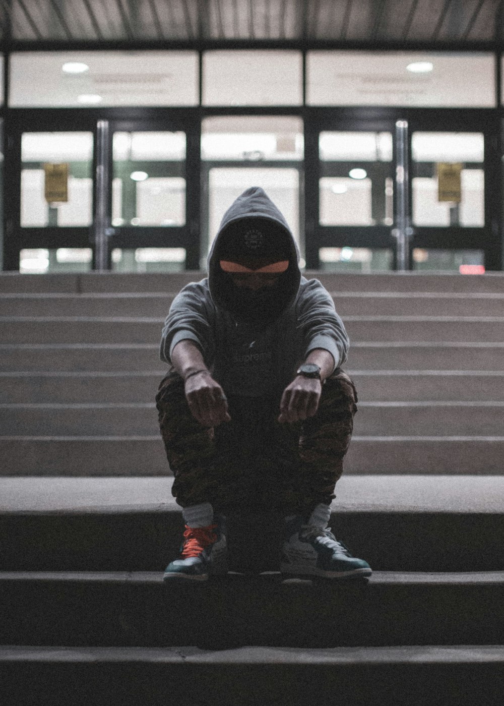 child in black hoodie and pants walking on pedestrian lane