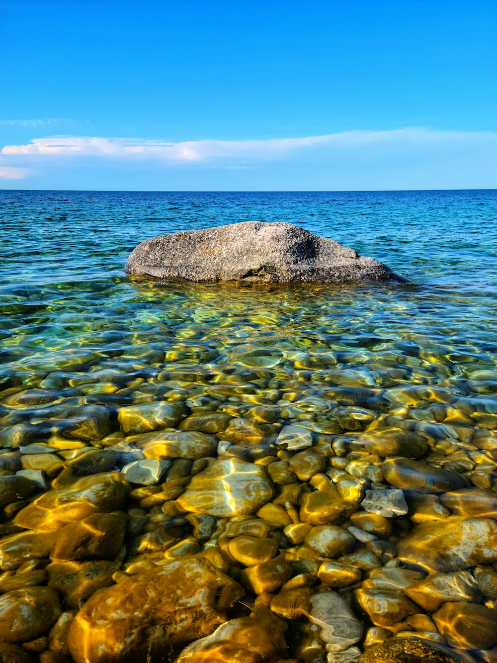 brown rock on body of water during daytime