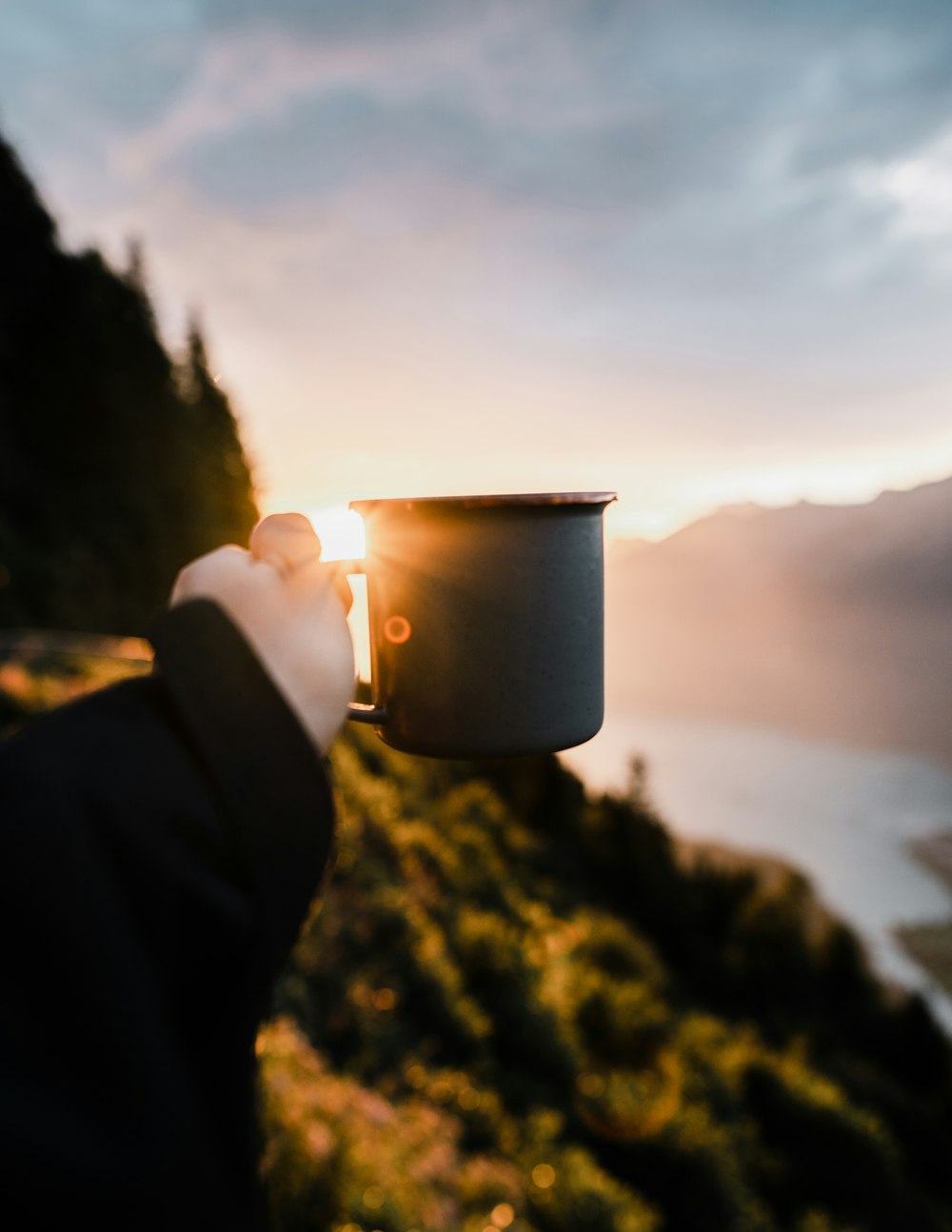 person holding white ceramic mug