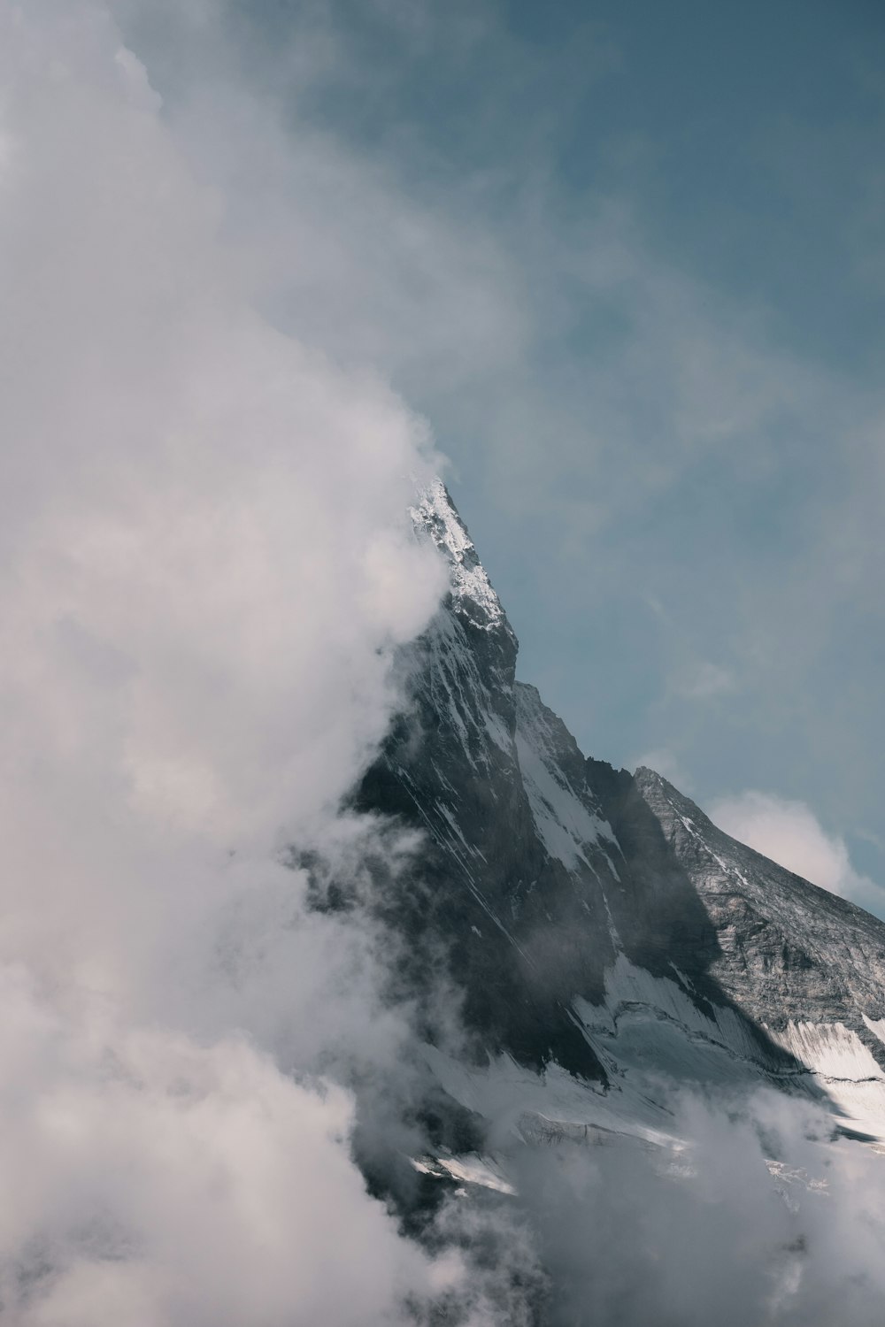 snow covered mountain under cloudy sky during daytime