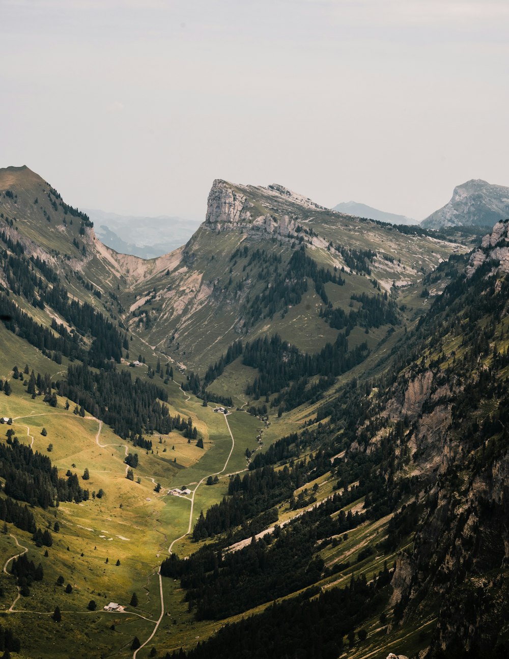 green and brown mountains under white sky during daytime