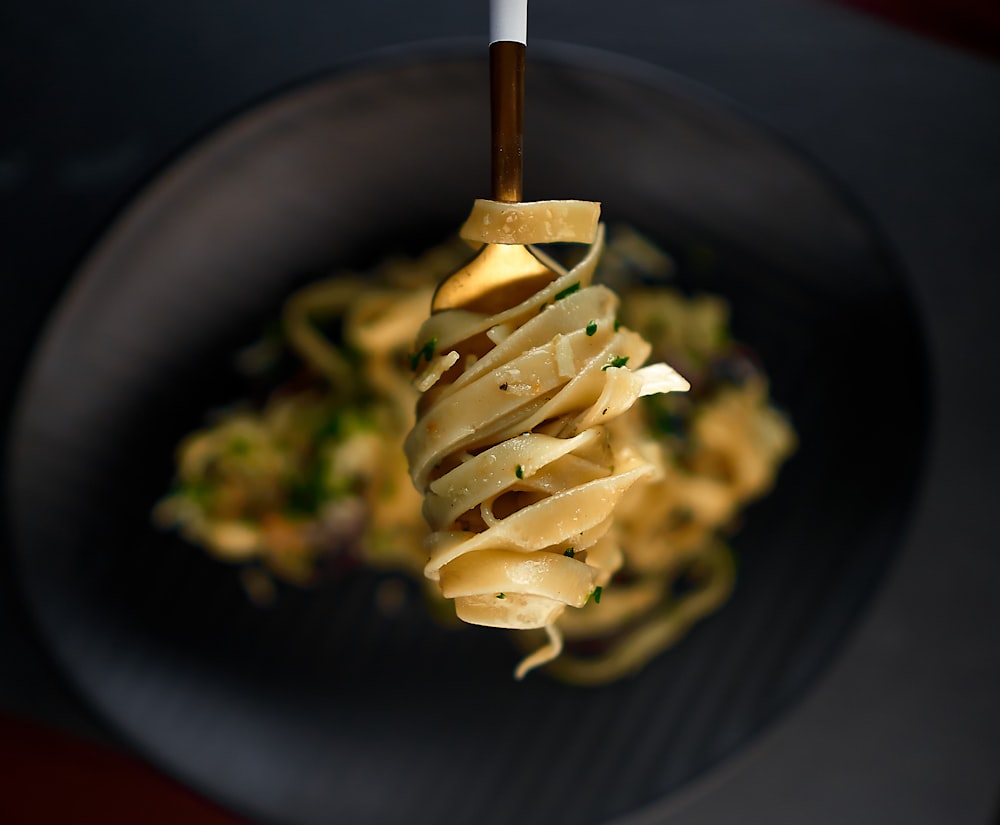 pasta dish on black ceramic plate