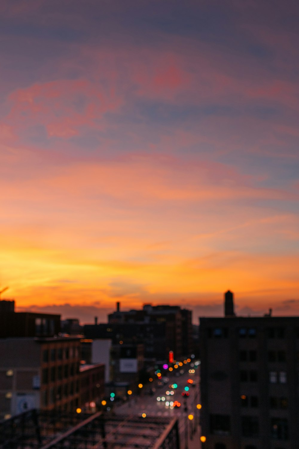 city buildings under orange sky during sunset