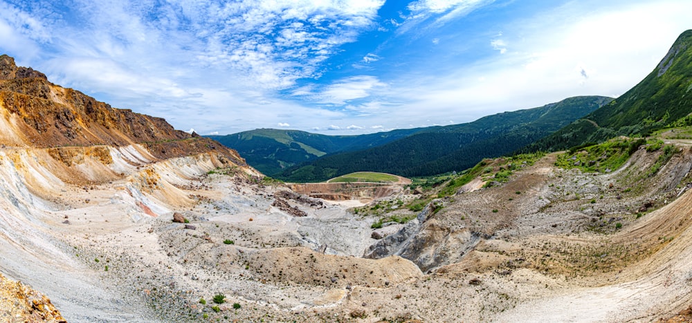 green trees on brown mountain under blue sky during daytime