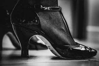 a black and white photo of a woman's shoes
