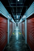 A well-lit corridor lined with storage units.