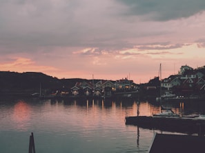 Sunset view over a charming coastal village with boats docked by the shore