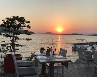 A luxurious cruise dinner setting with a stunning sunset view over the water.