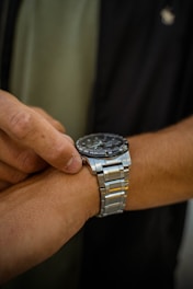 A dedicated individual ready to take on a mission immediately, checking their watch.