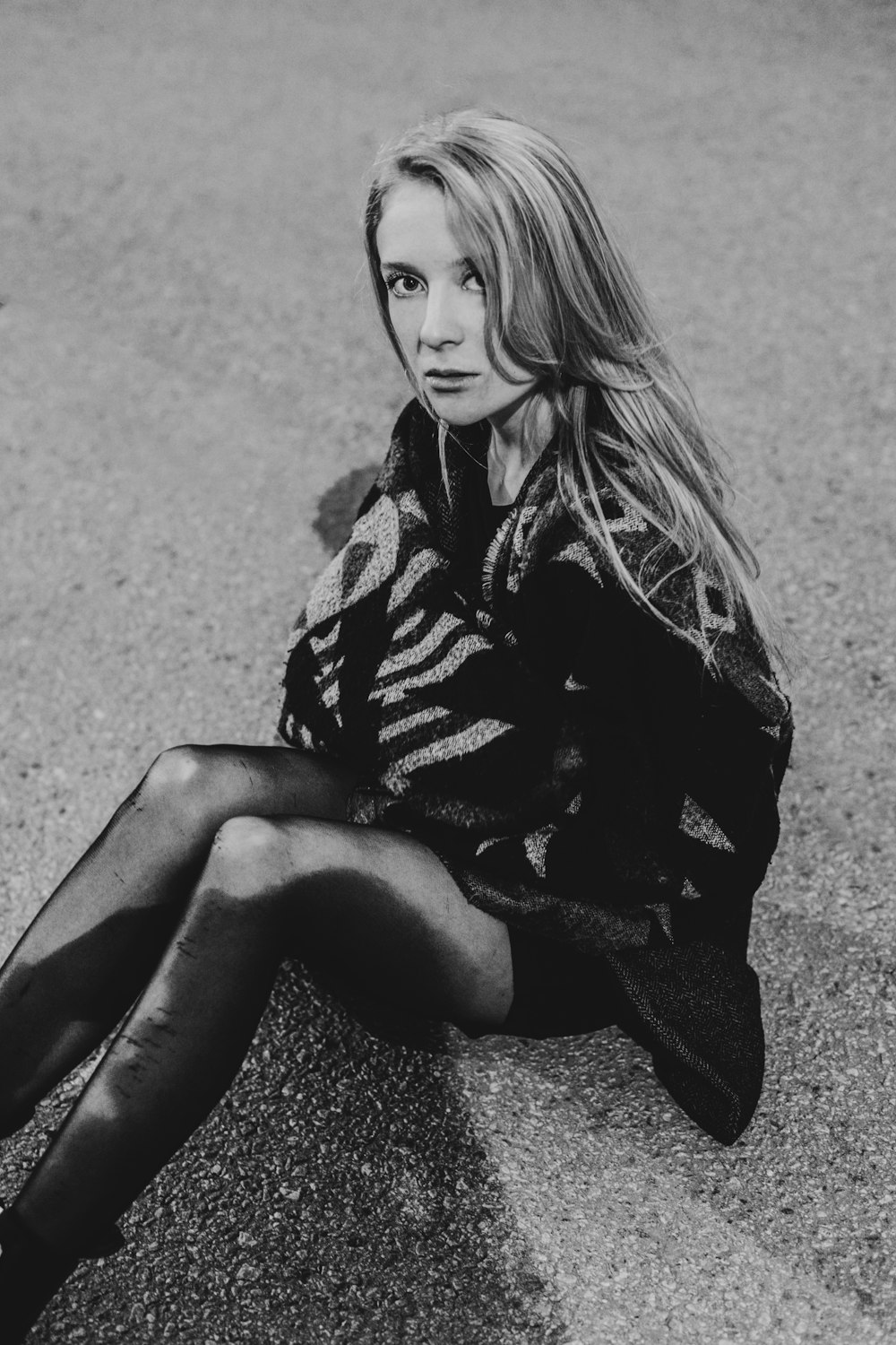 woman in black and white dress sitting on the ground