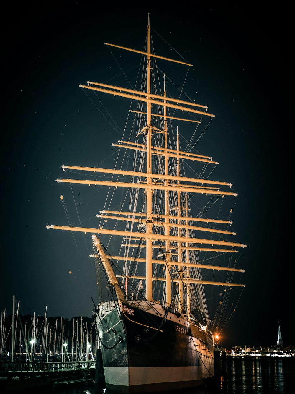 black and white ship on sea during night time