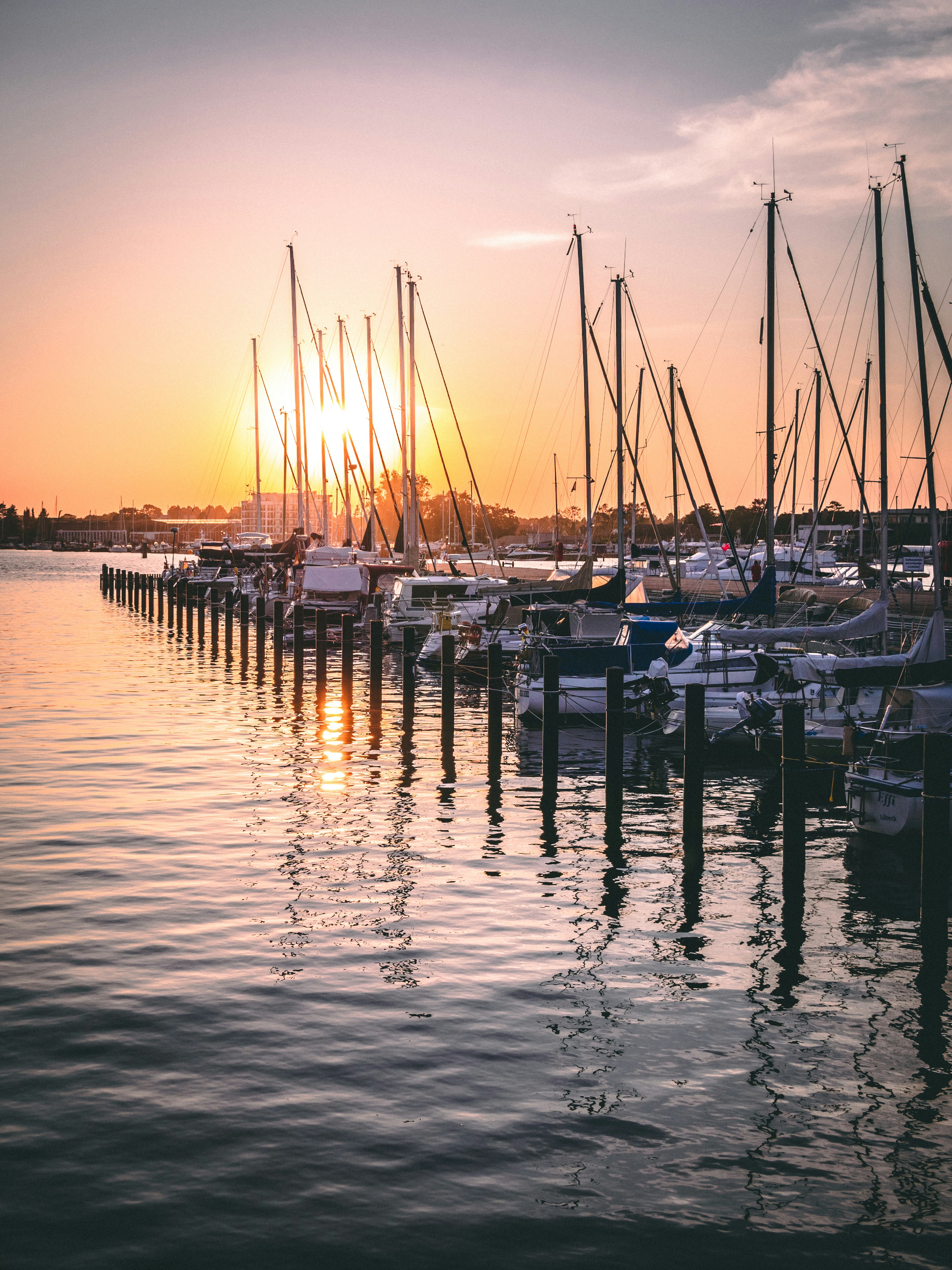 white and blue boats on sea during sunset
