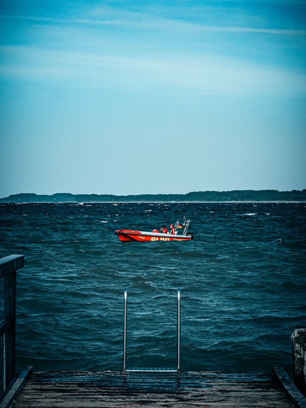 red and white boat on sea during daytime