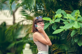 woman in white tank top and blue sunglasses
