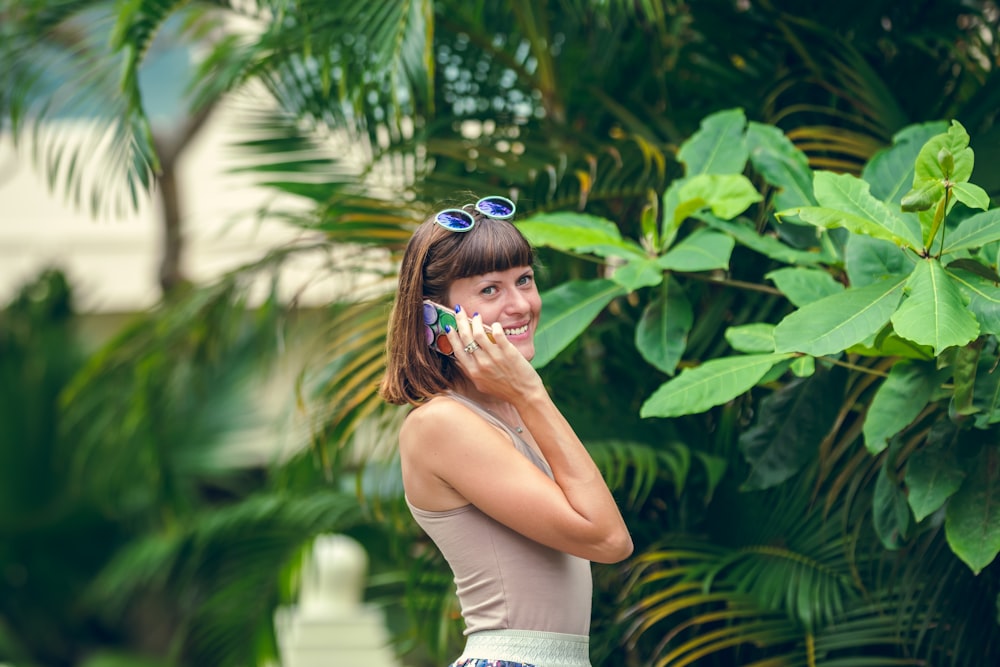 woman in white tank top and blue sunglasses