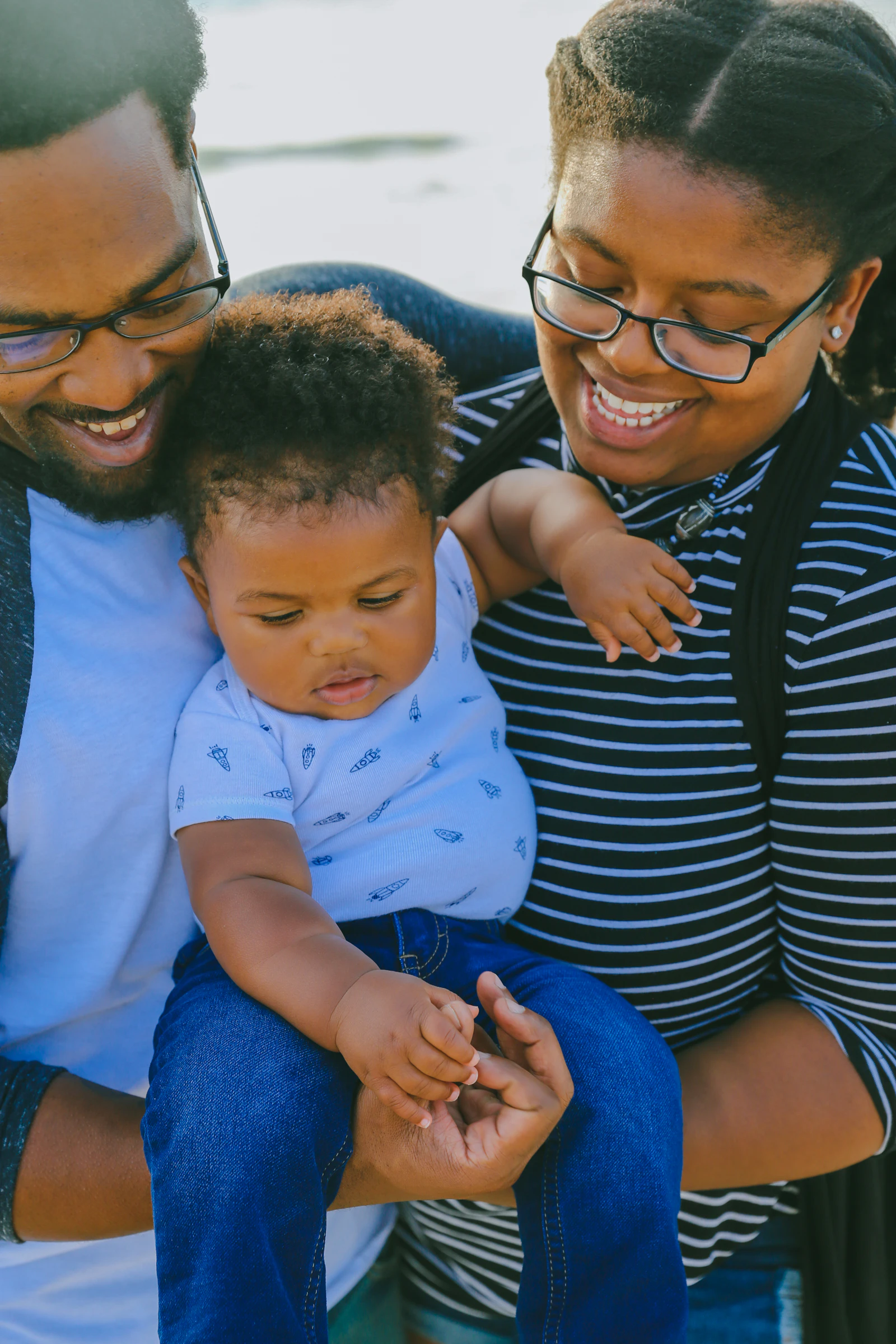 Black family seated with a financial educator during a financial education workshop
