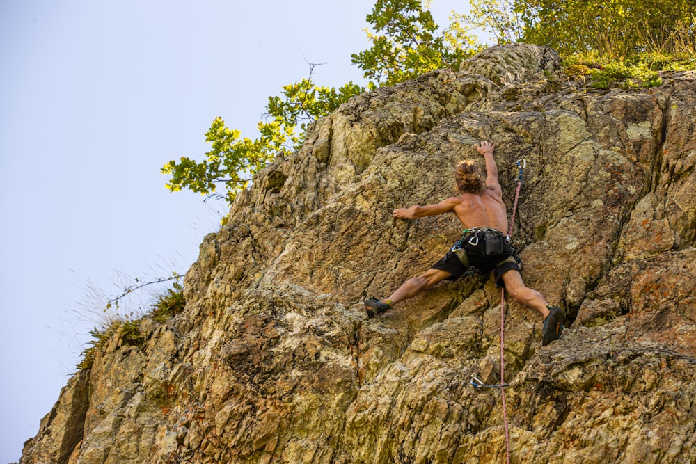 a man climbing up the side of a mountain