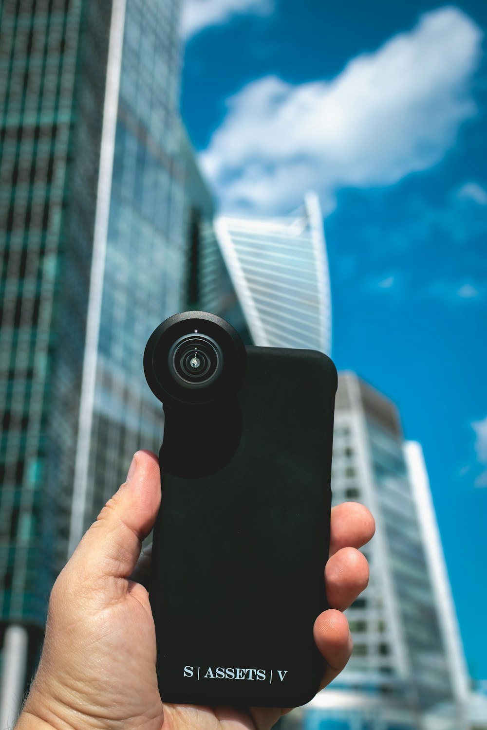 person holding black camera lens