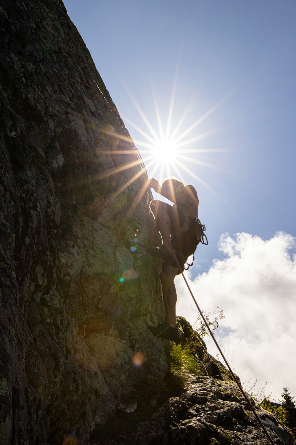 a man climbing up the side of a mountain