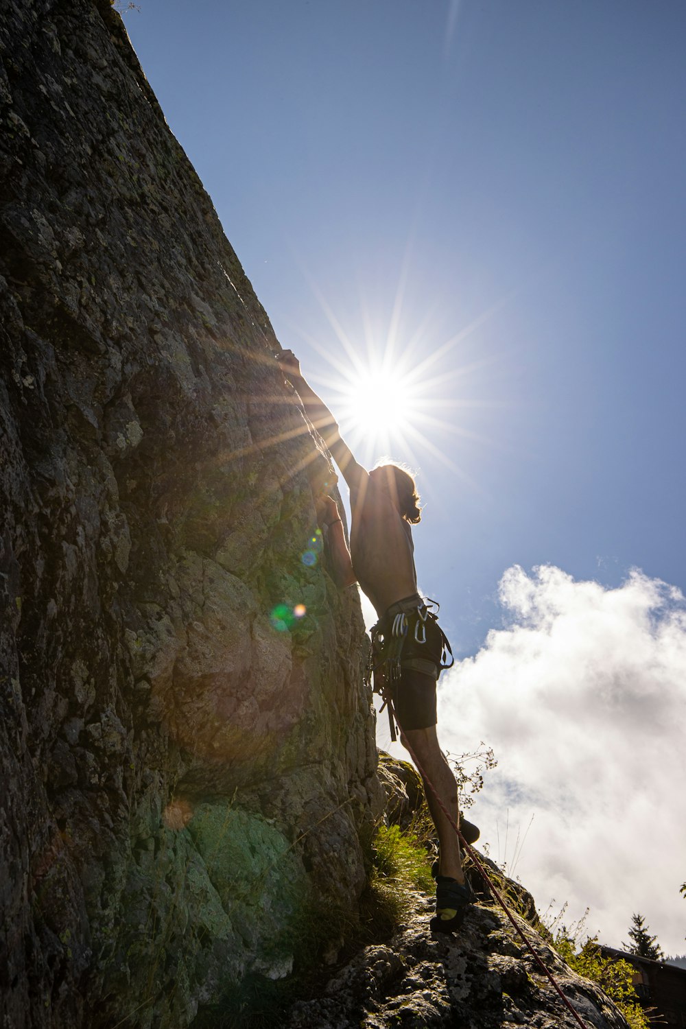 a man climbing up the side of a mountain