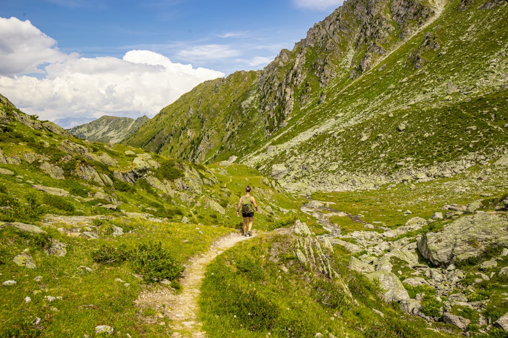 a person walking up a trail in the mountains