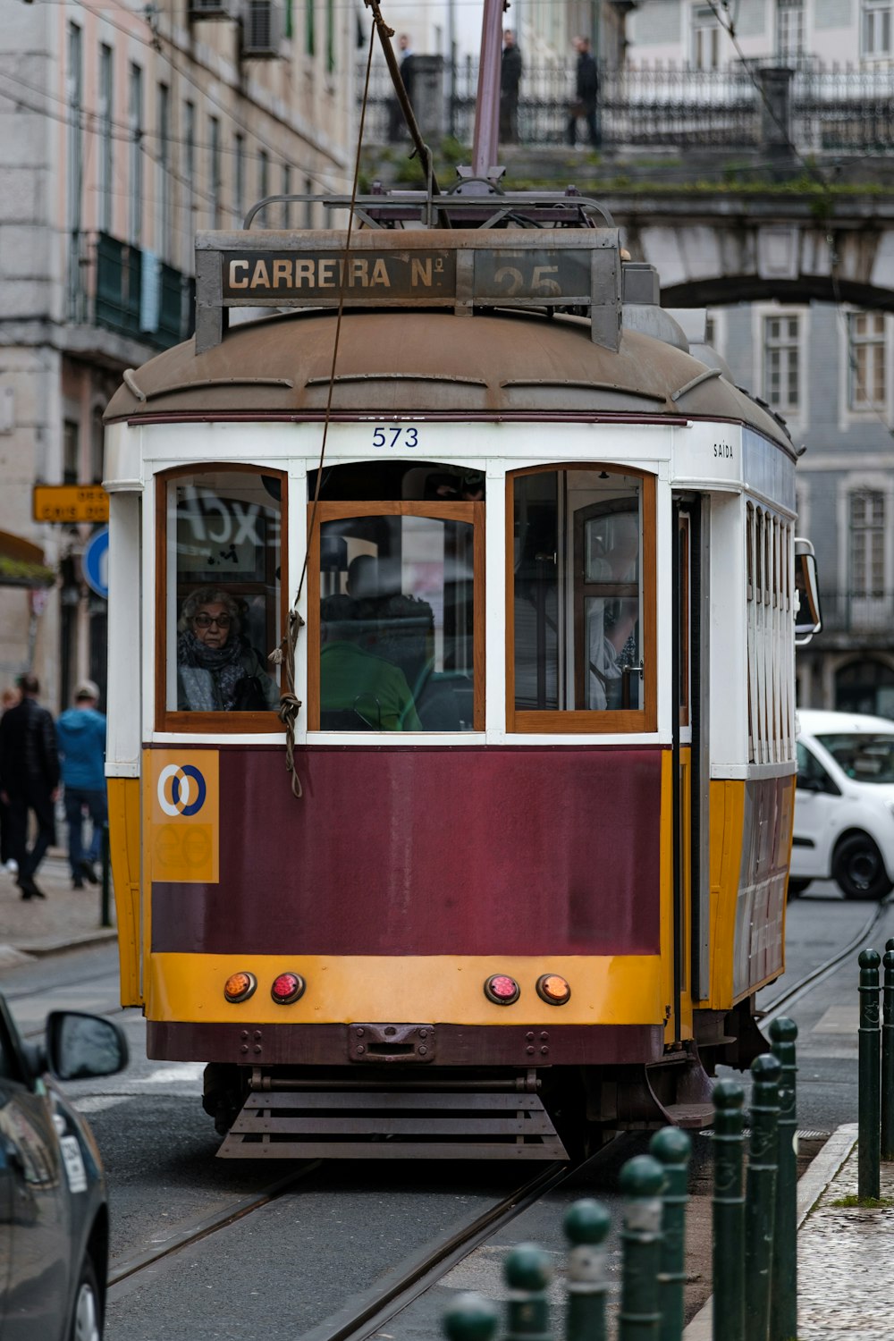 yellow and white tram on road during daytime