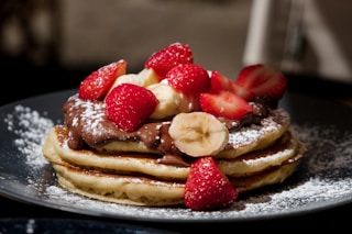 pancakes with strawberries and blueberries on top