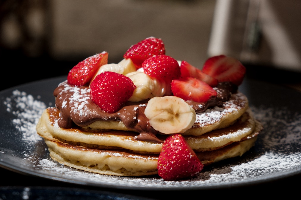 Stack of fluffy pancakes with fresh strawberries and blueberries — the kind of brunch spread Magnolia Table Waco is known for